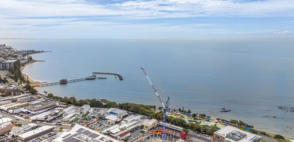 Tower crane on the waterfront at Redcliffe, seen along the jetty and coastline