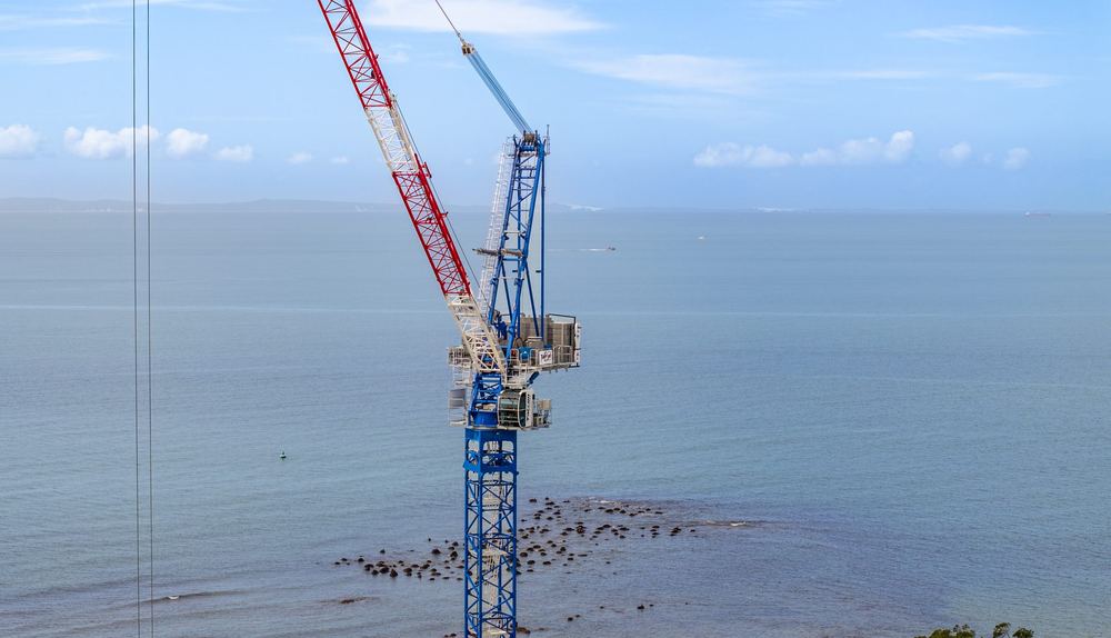 Luffing jib crane against the sky at Redcliffe, on the water's edge