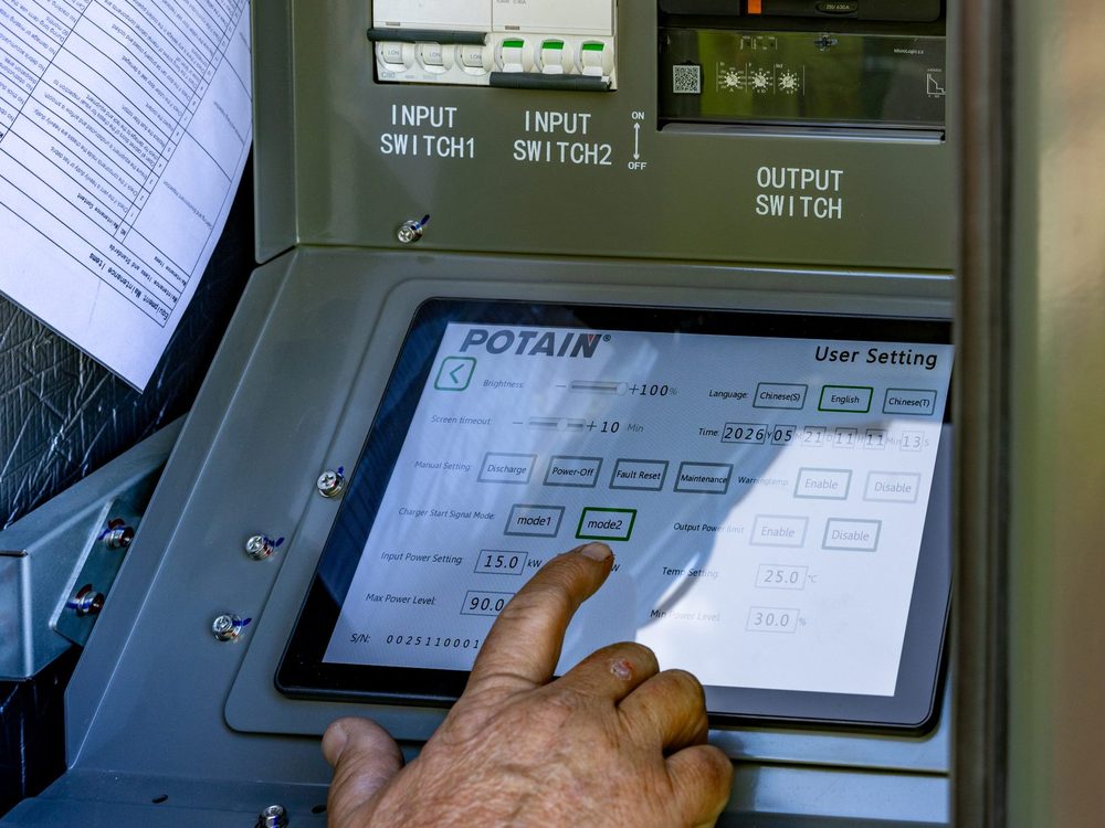 Technician working at a Potain control panel touchscreen